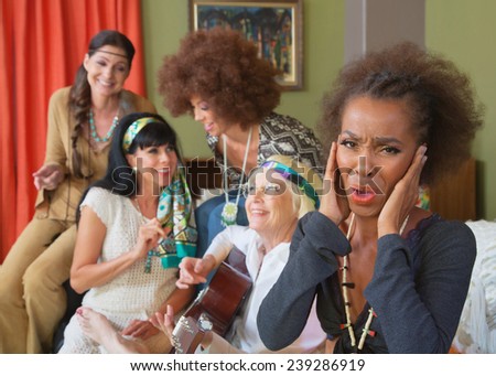 Annoyed woman with group of hippies playing music