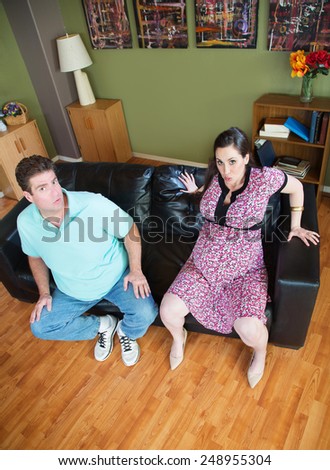 Man with pregnant woman stuck in sofa
