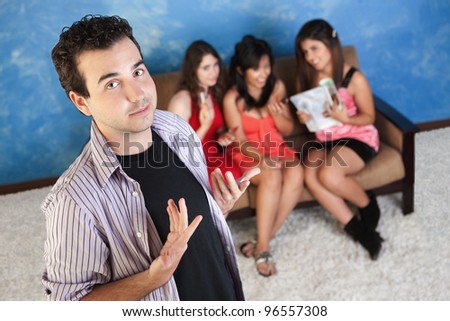 Arrogant young Caucasian man with three female admirers