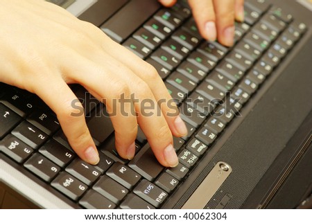 Female hands typing on laptop keyboard