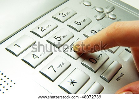 finger presses figure on a grey phone
