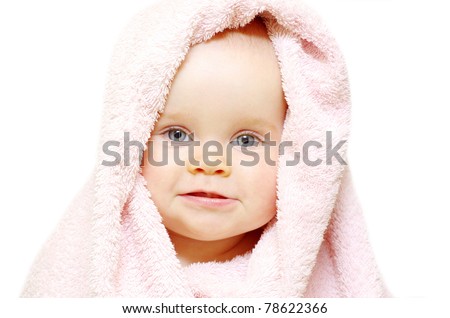 baby looking out from under blanket