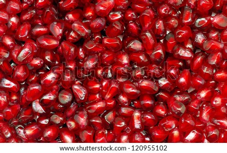 Macro of peeled ripe seeds pomegranate background