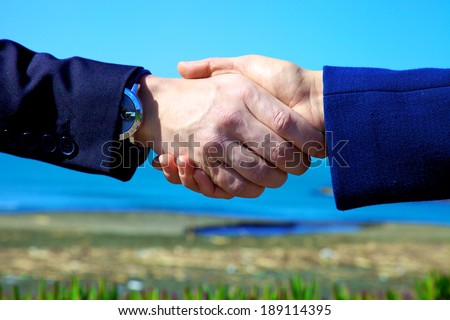 Strong confident hand shake between man and woman