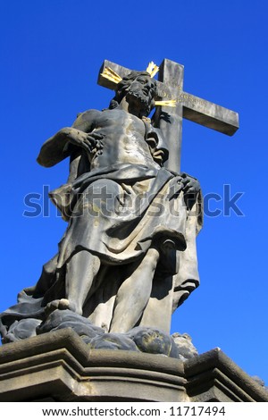 Jesus Christ with the Cross-statue on the Charles Bridge in Prague, Czech Republic (portrait orientation).
