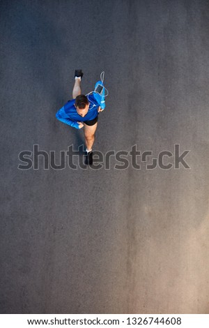 Similar – Image, Stock Photo Top view athlete runner training at road in black sportswear.