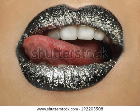 Beauty photograph (close-up) of black shiny female lips.
