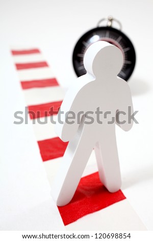 Danger of long working hours.  Male figure standing on chevron in front of clock