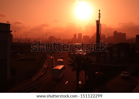 Sun setting over Durban city and harbor.  City scape at sunset.