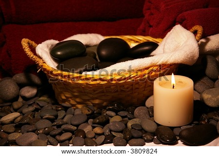 Basket of Massage Stones and candle