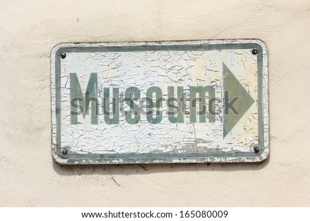 Weathered sign to a museum