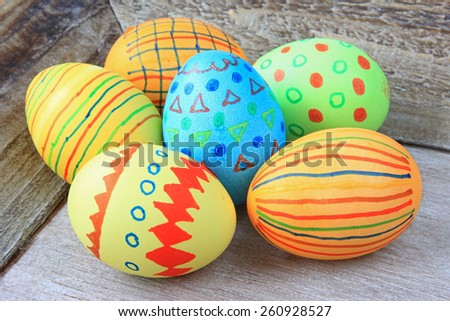 colorful painted Easter eggs on gray wood background