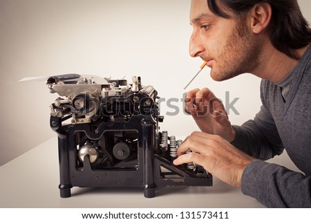 Man thinking at typewriter