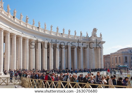 VATICAN CITY, VATICAN - MARCH 09, 2015: People at Saint Peter\'s Square. St. Peter\'s Square is a massive plaza located directly in front of St. Peter\'s Basilica in the Vatican City.