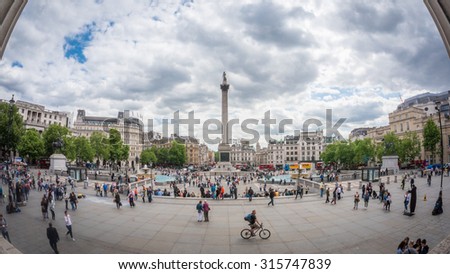LONDON, UK - JUNE 11, 2015: Tourists visit Trafalgar Square, London. One of the most popular tourist attraction on Earth it has more than fifteen million visitors a year