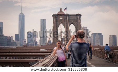 NEW YORK, USA - June 10: The pedestrian walkway along The Brooklyn Bridge in New York City on June 10, 2014. Approximately 4,000 pedestrians and 3,100 cyclists cross this historic bridge each day.
