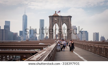 NEW YORK, USA - June 10: The pedestrian walkway along The Brooklyn Bridge in New York City on June 10, 2014. Approximately 4,000 pedestrians and 3,100 cyclists cross this historic bridge each day.