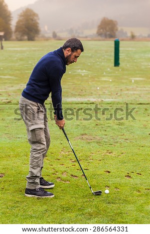 a golf player practicing the swing on the driving range