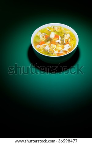 Spot of bright light on bowl of nice chicken soup