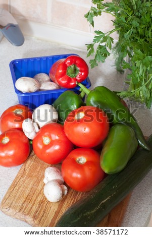 Close up of heap of fresh veggies on wooden board
