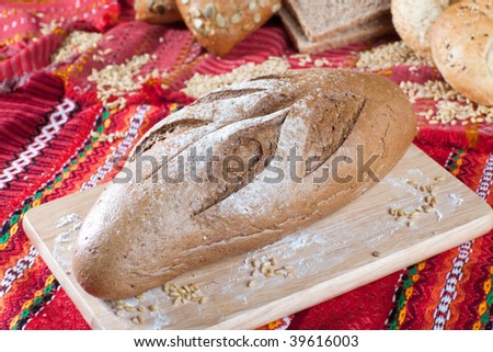 Close up of dietetic brown bread in fron of heap of other type of bread