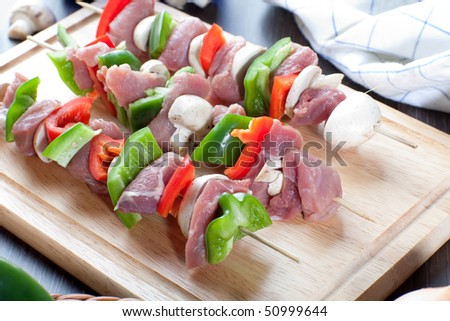 Close up of freshly made meat sticks on wooden board