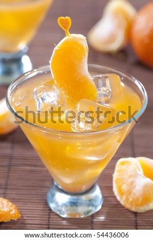 Tangerine cocktail on dark wooden table top