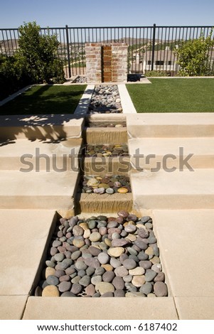 Backyard water feature and green lawn.