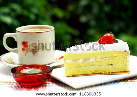Delicious breakfast that include a slice of cake and a cup of coffee.
