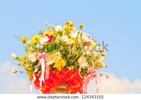 Beautiful white  gerberas and roses on blue sky background