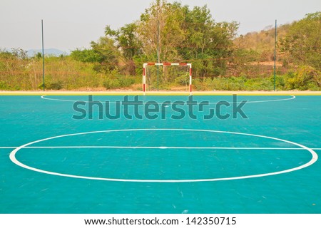An football field and  plastic floor near mountain