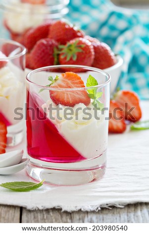 Dessert with strawberries, jelly and whipped cream