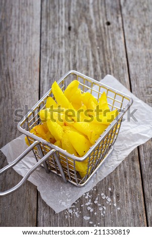 Homemade french fries in a tiny frying basket