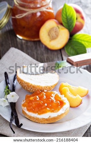 Vanilla peach jam on bread with vanilla sticks and fresh peaches