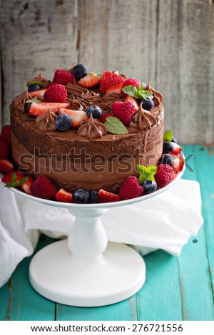 Chocolate cheesecake and devil food layer cake with fresh berries