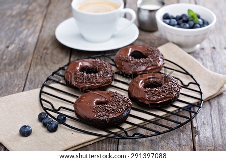 Chocolate gluten free donuts with coffee and blueberries