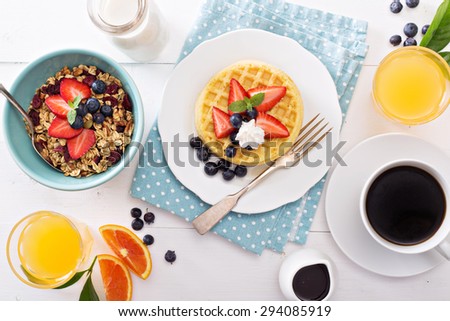 Breakfast waffles with fresh berries stacked on a plate