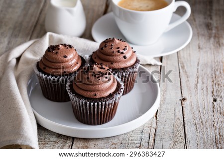 Chocolate cupcakes with a cup of hot black coffee