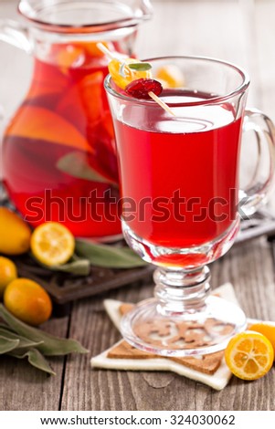 Cranberry and orange holiday punch with sage in a glass
