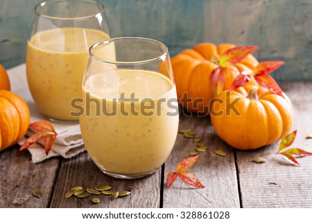 Healthy pumpkin smoothie with chia seed in glasses on rustic background