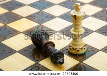 white beating black king on chessboard
