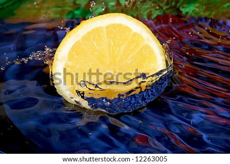 Splash with fresh mandarin. Pure water. Blue background.