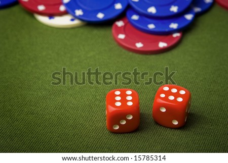 Red dice and chips on green felt