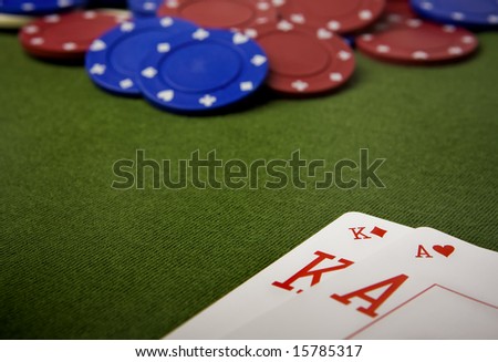 Blackjack and chips on green felt