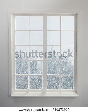 Modern residential window with snow and trees
