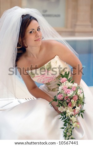 Smiling beautiful bride in traditional white wedding dress