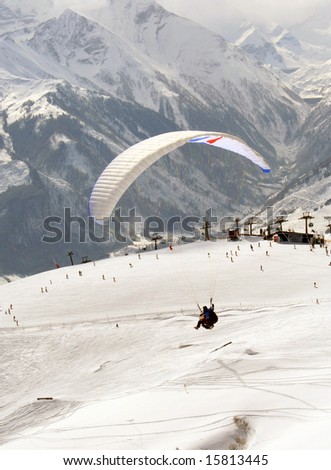 Para sailing in Swiss Alps in the winter snow.
