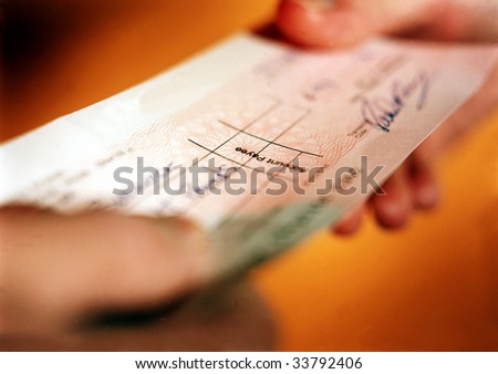 Person handing over check in financial transaction.