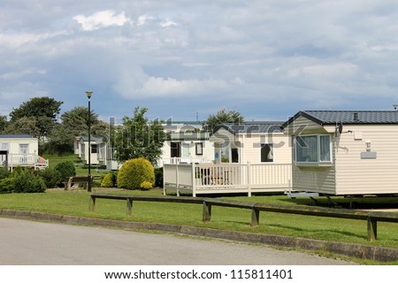 Scenic view of caravan trailer park with road in foreground.