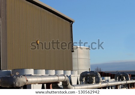 Exterior of modern factory building with external pipe.